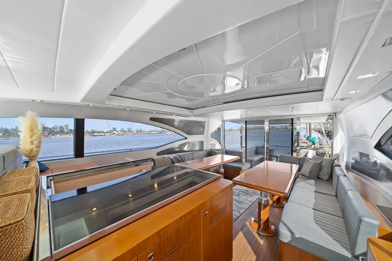 Double Down Yacht Photos Pics Luxurious interior of 2010 Mangusta 72 Express yacht with elegant seating and panoramic windows.