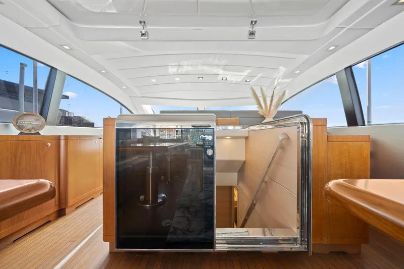 Double Down Yacht Photos Pics Interior of 2010 Mangusta 72 Express yacht with modern design and wooden cabinetry.