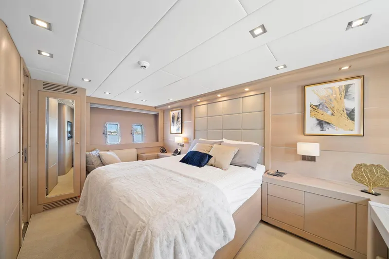 Double Down Yacht Photos Pics Luxurious bedroom interior of 2010 Mangusta 72 Express yacht with modern decor and elegant furnishings.
