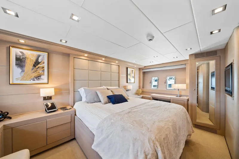 Double Down Yacht Photos Pics Luxurious bedroom interior of 2010 Mangusta 72 Express yacht with modern decor and elegant furnishings.