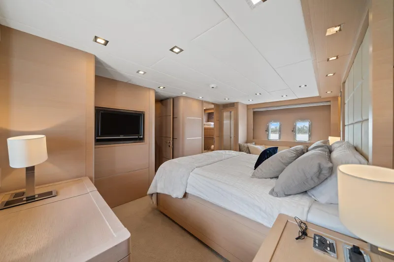 Double Down Yacht Photos Pics Luxurious bedroom interior of 2010 Mangusta 72 Express yacht with modern design and cozy ambiance.