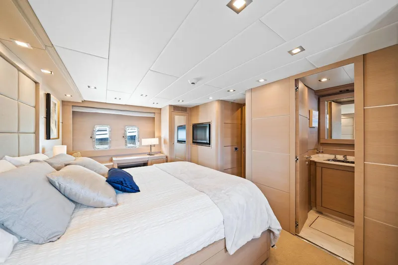 Double Down Yacht Photos Pics Luxurious bedroom interior of 2010 Mangusta 72 Express yacht with modern design and elegant furnishings.