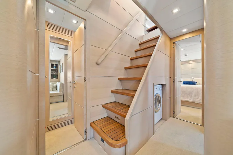 Double Down Yacht Photos Pics Interior of 2010 Mangusta 72 Express yacht with wooden stairs and modern design.