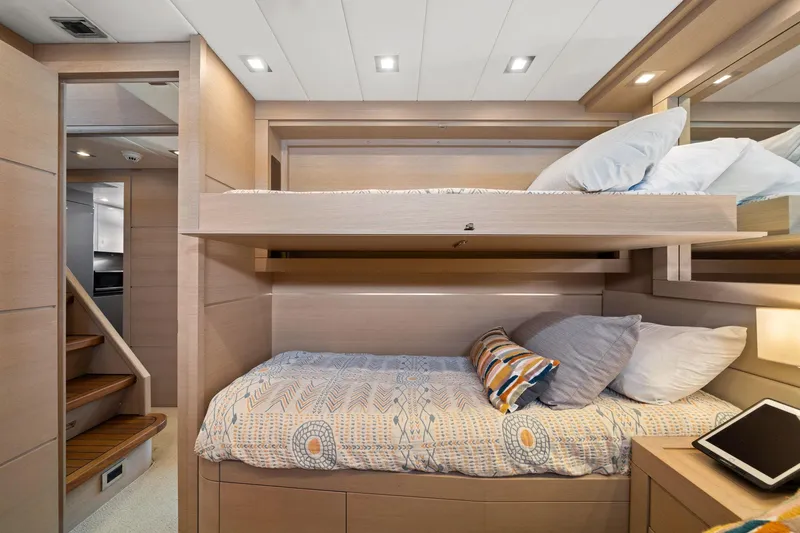 Double Down Yacht Photos Pics Luxurious cabin interior of 2010 Mangusta 72 Express yacht with bunk beds and modern decor.