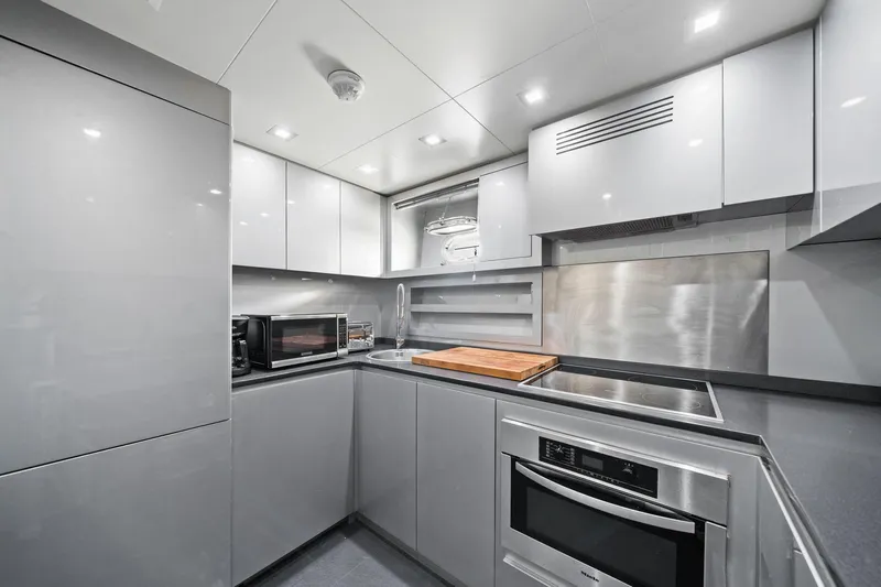 Double Down Yacht Photos Pics Modern kitchen interior in 2010 Mangusta 72 Express yacht, featuring sleek cabinetry and appliances.