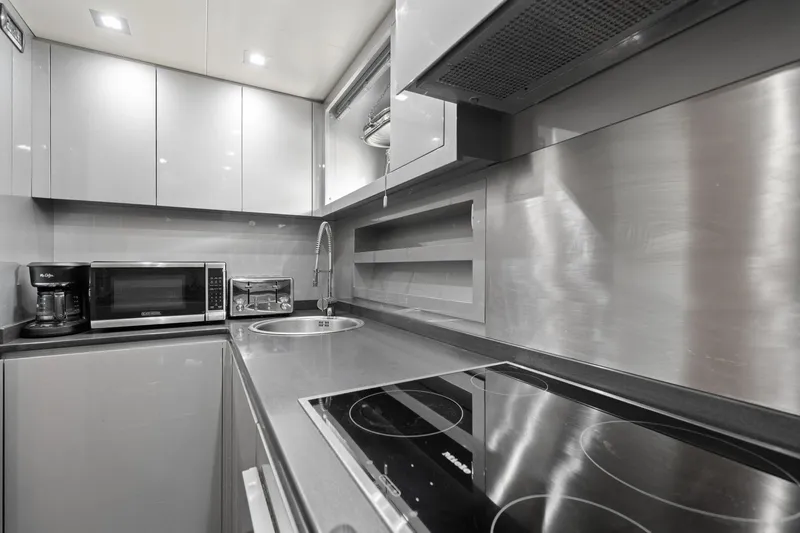 Double Down Yacht Photos Pics Modern kitchen in 2010 Mangusta 72 Express yacht with sleek appliances and stainless steel finishes.