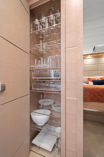 Double Down Yacht Photos Pics Luxurious glassware cabinet in 2010 Mangusta 72 Express yacht interior.