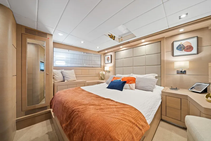Double Down Yacht Photos Pics Luxurious bedroom interior of 2010 Mangusta 72 Express yacht with modern decor and cozy bedding.