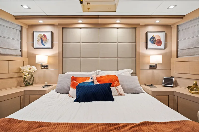 Double Down Yacht Photos Pics Luxurious bedroom interior of 2010 Mangusta 72 Express yacht with modern decor and ambient lighting.