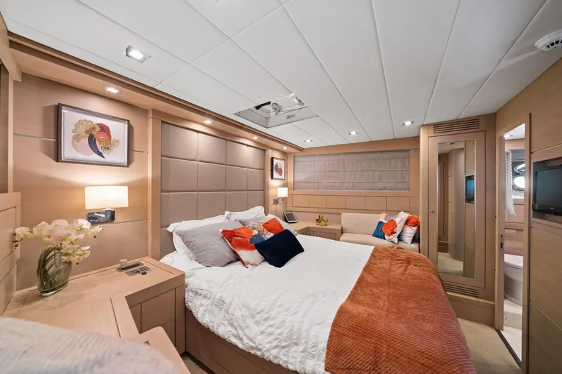 Double Down Yacht Photos Pics Luxurious bedroom interior of 2010 Mangusta 72 Express yacht with modern decor and cozy bedding.