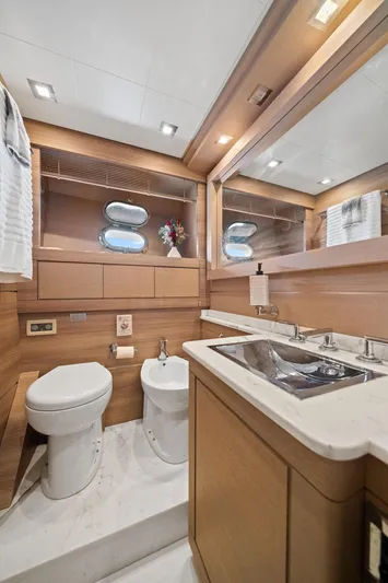 Double Down Yacht Photos Pics Luxurious bathroom in 2010 Mangusta 72 Express yacht with modern fixtures and wood accents.