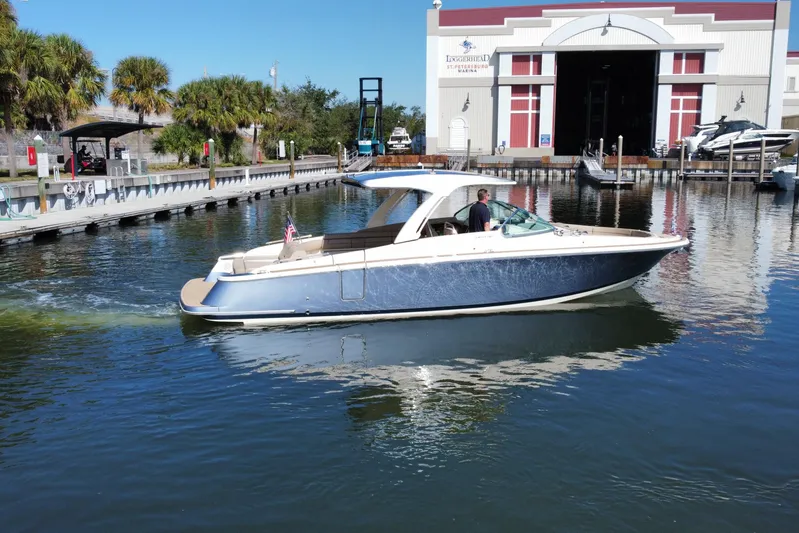  Yacht Photos Pics 2022 Chris-Craft Launch 35 GT I/O boat cruising near a marina on a sunny day.