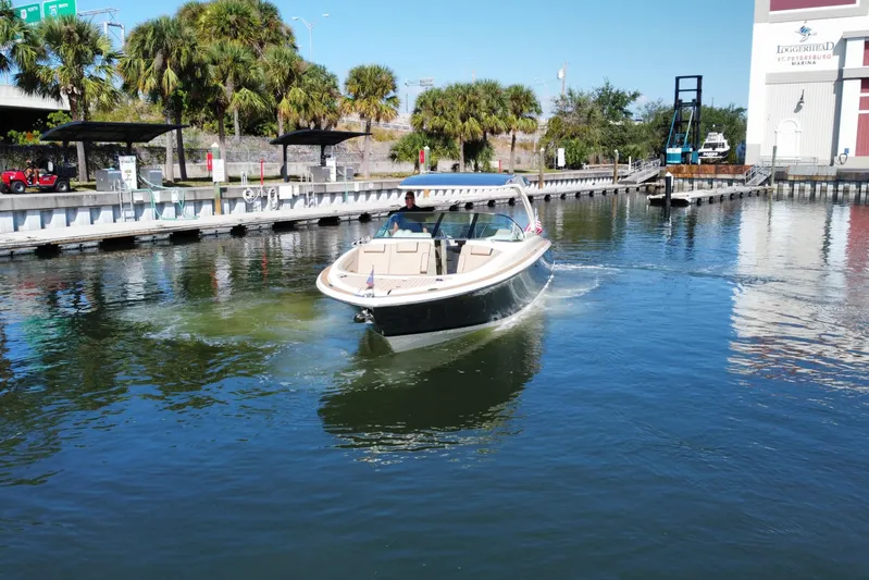  Yacht Photos Pics 2022 Chris-Craft Launch 35 GT I/O cruising in a marina with palm trees.