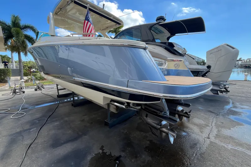  Yacht Photos Pics 2022 Chris-Craft Launch 35 GT I/O boat on dock, showcasing sleek design and dual propellers.