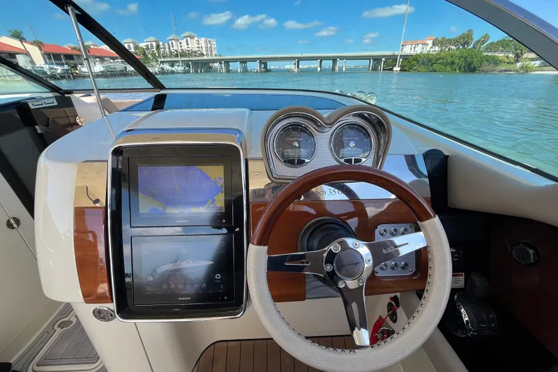  Yacht Photos Pics 2022 Chris-Craft Launch 35 GT I/O dashboard with navigation screens and steering wheel.