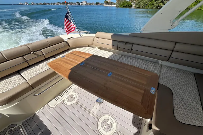  Yacht Photos Pics 2022 Chris-Craft Launch 35 GT I/O interior with seating and wooden table on water.