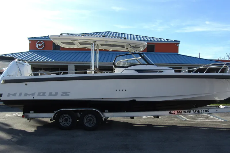  Yacht Photos Pics 2025 Nimbus Tender 9 boat on trailer, parked outside a building.