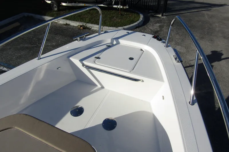  Yacht Photos Pics 2025 Nimbus Tender 9 boat deck with stainless steel railings and storage compartment.