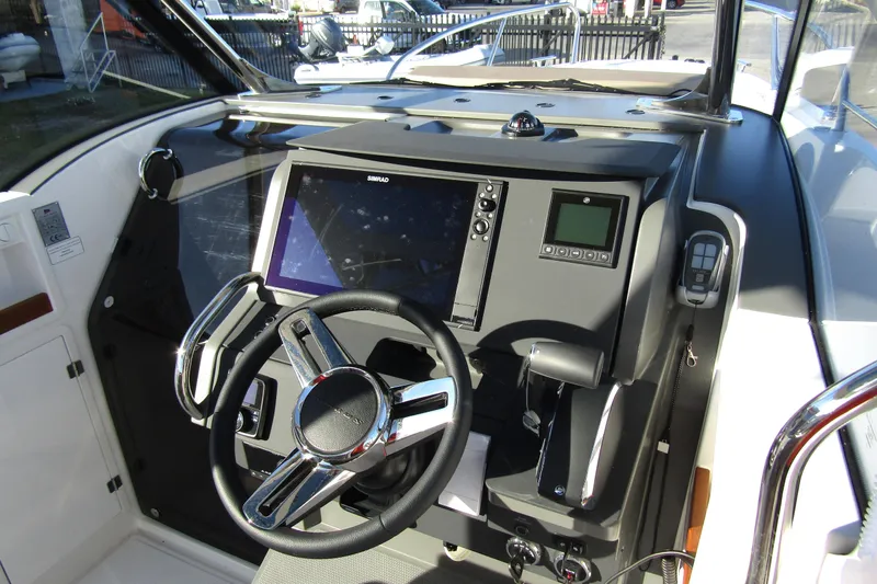  Yacht Photos Pics Helm of 2025 Nimbus Tender 9 with modern navigation system and steering wheel.