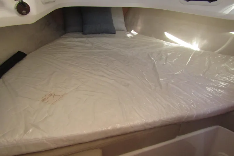  Yacht Photos Pics Interior cabin bed of 2025 Nimbus Tender 9 boat, covered in protective plastic.
