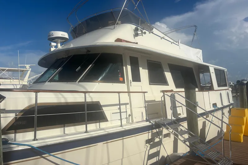 Ruby Yacht Photos Pics 1981 Hatteras 56 Motor Yacht docked under a clear blue sky.