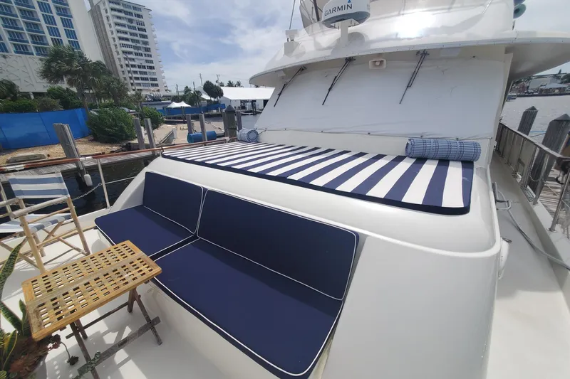 Ruby Yacht Photos Pics 1981 Hatteras 56 Motor Yacht with striped sunbed and blue seating on deck.