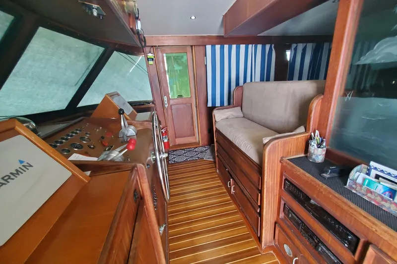 Ruby Yacht Photos Pics Interior of 1981 Hatteras 56 Motor Yacht with wood paneling and navigation equipment.