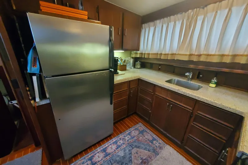 Ruby Yacht Photos Pics Kitchen area of a 1981 Hatteras 56 Motor Yacht with stainless steel fridge.