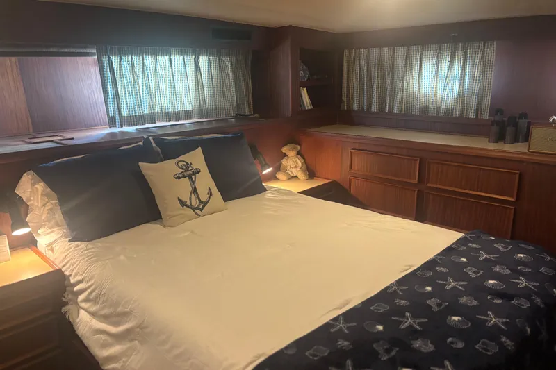Ruby Yacht Photos Pics Cozy bedroom in 1981 Hatteras 56 Motor Yacht with nautical decor and wood paneling.