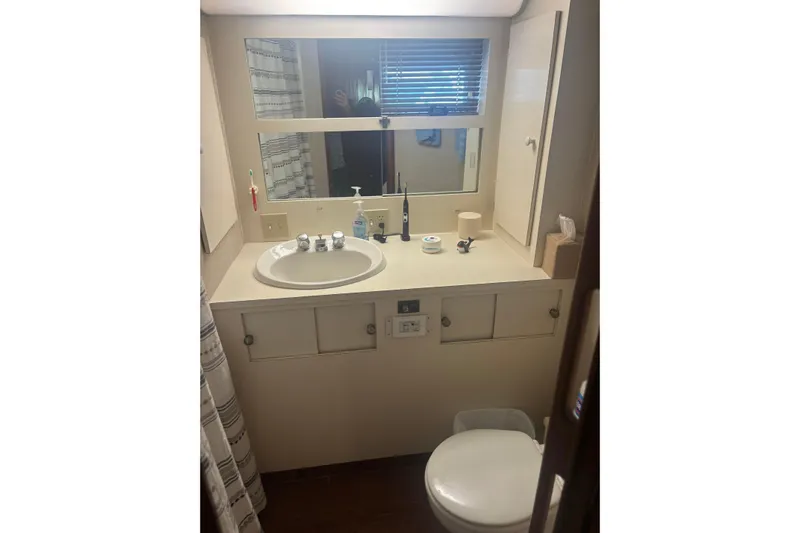 Ruby Yacht Photos Pics Bathroom interior of 1981 Hatteras 56 Motor Yacht with sink and mirror.