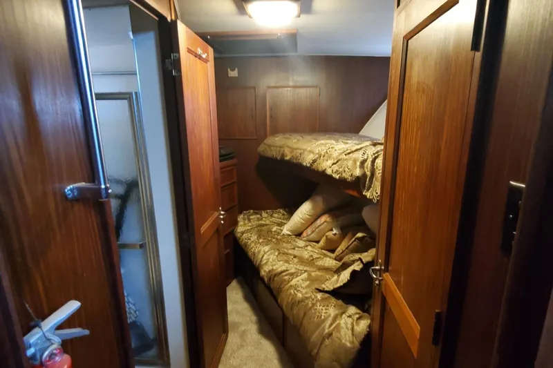Ruby Yacht Photos Pics Interior cabin of 1981 Hatteras 56 Motor Yacht with bunk beds and wooden finish.