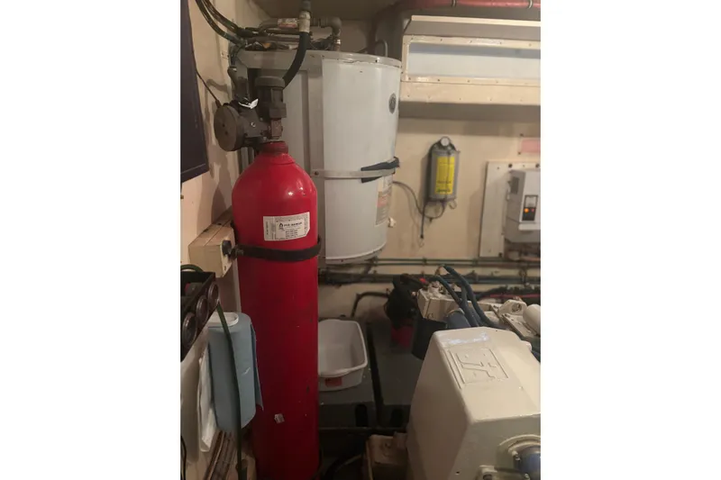 Ruby Yacht Photos Pics Engine room of 1981 Hatteras 56 Motor Yacht with fire extinguisher and equipment.