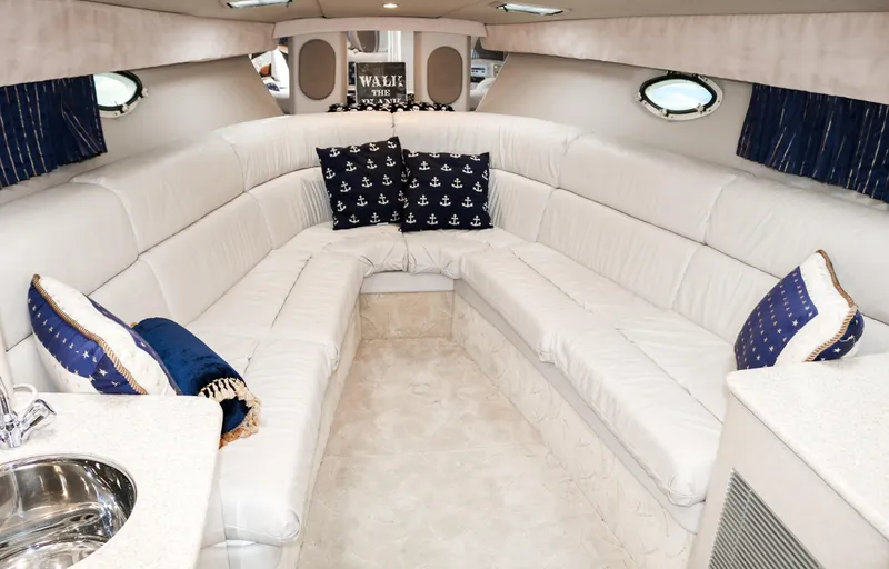  Yacht Photos Pics Interior of 2003 Formula 370 Super Sport boat with white leather seating and nautical-themed pillows.
