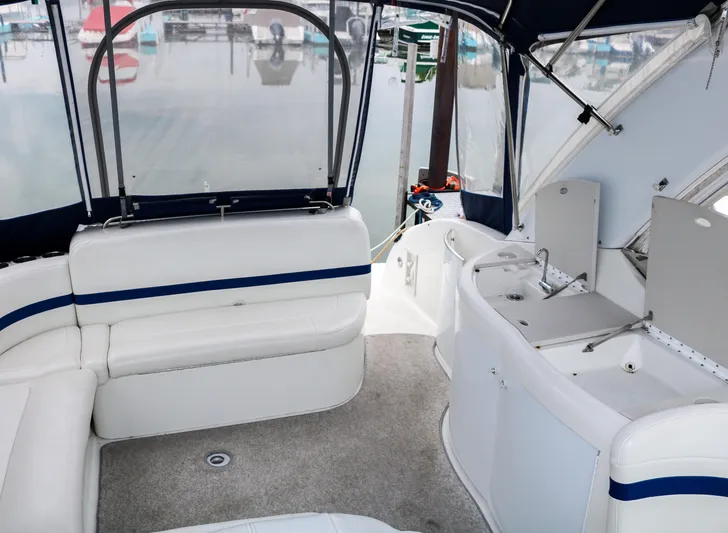  Yacht Photos Pics Interior of a 2003 Formula 370 Super Sport boat with white seating and covered deck.