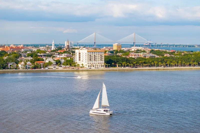 Cielo Yacht Photos Pics Sailboat Bali 4.2 cruising near cityscape with bridge in background, 2023.