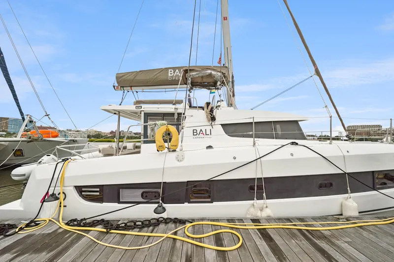 Cielo Yacht Photos Pics 2023 Bali 4.2 catamaran docked at marina, side view with clear sky.