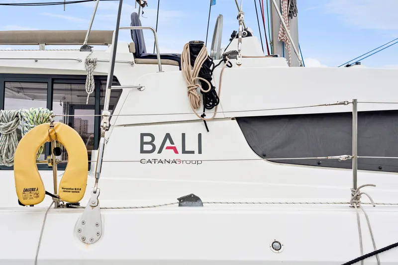 Cielo Yacht Photos Pics 2023 Bali 4.2 catamaran side view with safety equipment and ropes.
