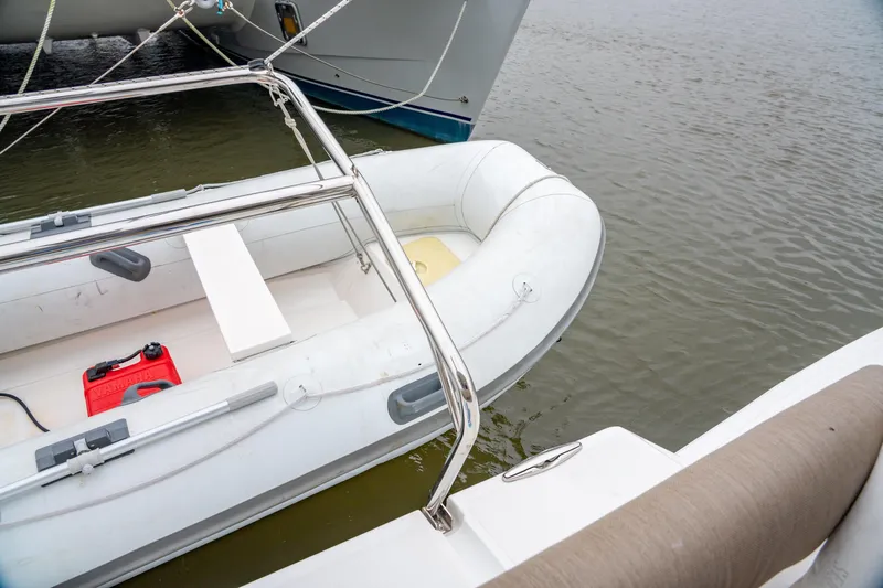 Cielo Yacht Photos Pics Inflatable dinghy beside Bali 4.2 catamaran, 2023 model, on calm water.