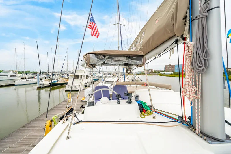 Cielo Yacht Photos Pics 2023 Bali 4.2 yacht docked at marina with American flag, clear sky.