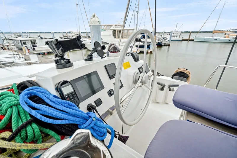 Cielo Yacht Photos Pics Cockpit of 2023 Bali 4.2 yacht with steering wheel and navigation equipment in marina.
