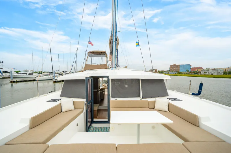 Cielo Yacht Photos Pics 2023 Bali 4.2 catamaran with spacious deck, docked in a marina under a blue sky.