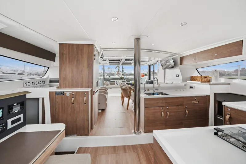 Cielo Yacht Photos Pics Luxurious interior of 2023 Bali 4.2 yacht with modern kitchen and seating area.