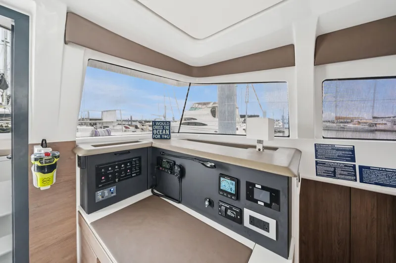 Cielo Yacht Photos Pics Interior of 2023 Bali 4.2 yacht with control panel and marina view.