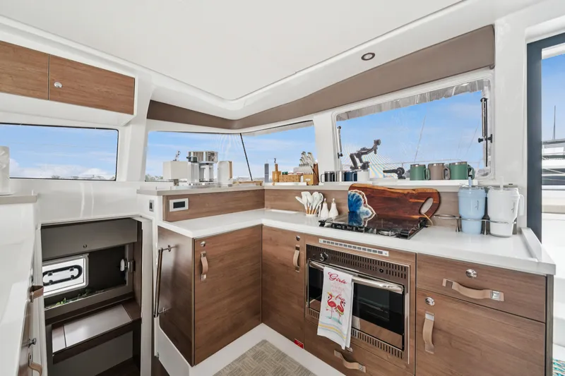 Cielo Yacht Photos Pics Modern kitchen interior on 2023 Bali 4.2 yacht, featuring wood cabinetry and ocean views.