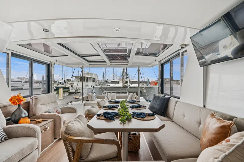 Cielo Yacht Photos Pics Luxurious interior of 2023 Bali 4.2 yacht with elegant seating and marina view.