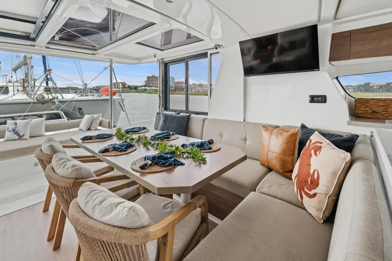 Cielo Yacht Photos Pics Luxurious interior of 2023 Bali 4.2 yacht with elegant dining area and waterfront view.