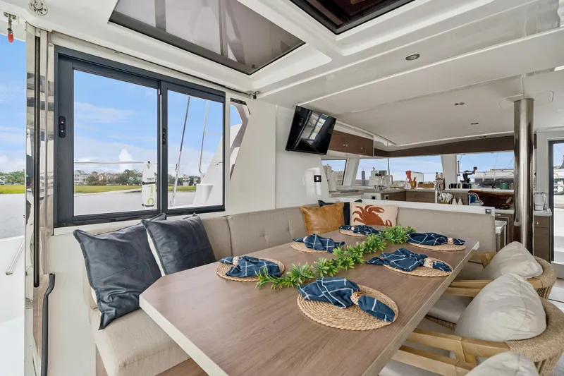 Cielo Yacht Photos Pics Luxurious interior of 2023 Bali 4.2 yacht with elegant dining area and scenic views.