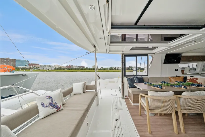 Cielo Yacht Photos Pics Luxurious 2023 Bali 4.2 yacht interior with spacious seating and scenic waterfront view.