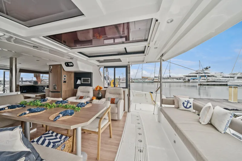 Cielo Yacht Photos Pics Luxurious 2023 Bali 4.2 yacht interior with elegant dining area and marina view.