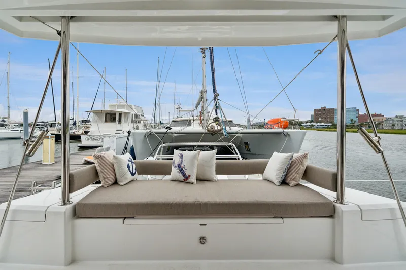 Cielo Yacht Photos Pics Luxurious Bali 4.2 catamaran with cushioned seating, docked at a marina, 2023 model.